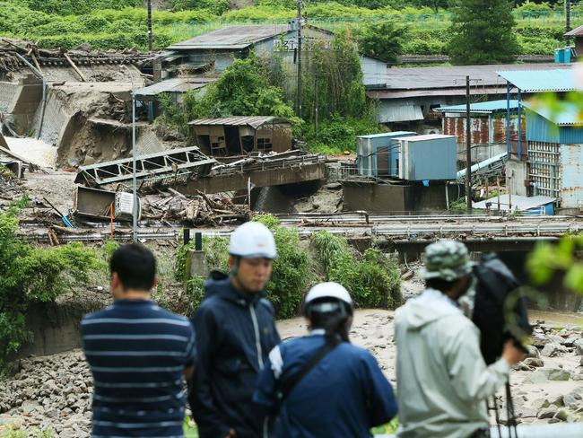 A TV crew works near the Nashizawa river in central Japan following a mudslide. Picture: AFP/Jiji