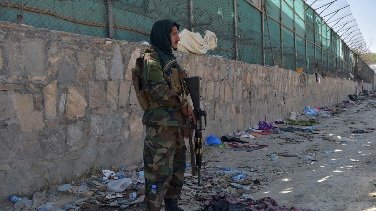 A Taliban fighter stands guard at the site of the twin suicide bomb attack, which killed scores of people including 13 US troops, at Kabul airport. Picture: Wakil Kohsar/AFP