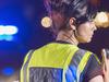 Female police officer at night, talking on radio