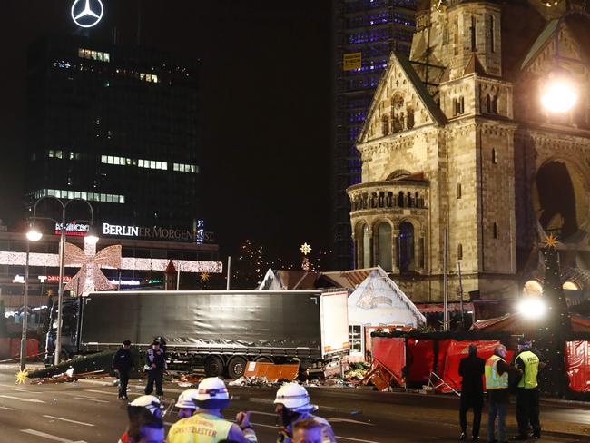 police and firefighters work around the truck that crashed into a Christmas market at Gedächniskirche Church in Berlin. Picture: AFP