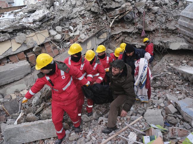 Local people and rescue volunteers retrieve a body during rescue operations in Elbistan Turkey. Picture: Getty Images