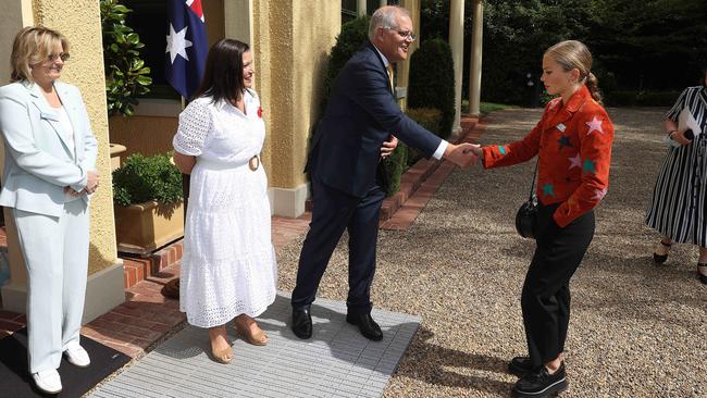 Grace Tame appears to reluctantly accepts the PM’s hand. Picture: NCA NewsWire / Gary Ramage