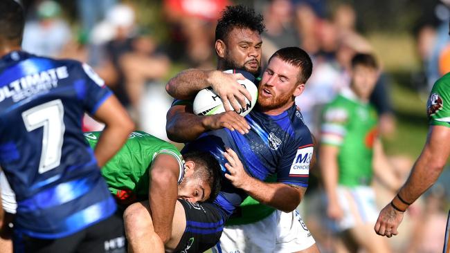 Dean Britt is wrapped up by the Raiders defence. Picture: Gregg Porteous/NRL Photos