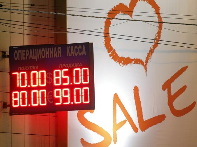 epa04531417 An electronic information panel displays the latest currency exchange rates outside a shopping centre in Moscow, 16 December 2014. The Russian rouble plunged to record lows 16 December, defying a 6.5-point interest rate hike by the central bank. The euro soared to 100 roubles in afternoon trading while the dollar rose to 80 against the rouble, meaning that the Russian currency lost more than 20 per cent of its value in a single day. The collapse is a slap in the face to Russia's central bank, which tried to shore up the currency with an interest rate hike to 17 per cent during the night. EPA/MAXIM SHIPENKOV