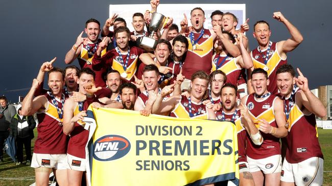 Lower Plenty celebrate with cup and flag after winning the NFL Division 2 grand final between Eltham and Lower Plenty played at Cramer St Oval in Preston on Saturday 15th September, 2018.