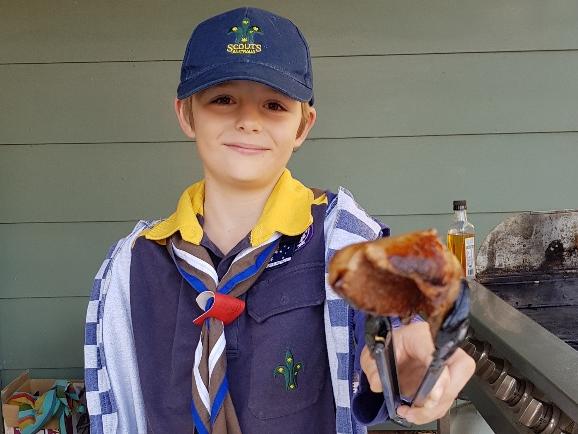 Joshua Bourne of 1st Point Clare Scouts cooking up the democracy sausages.