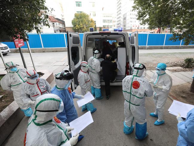 Medical staff assist a patient infected by the COVID-19 coronavirus leaving from Wuhan No. 3 Hospital to travel to Huoshenshan Hospital in Wuhan in China's central Hubei province. Picture: AFP