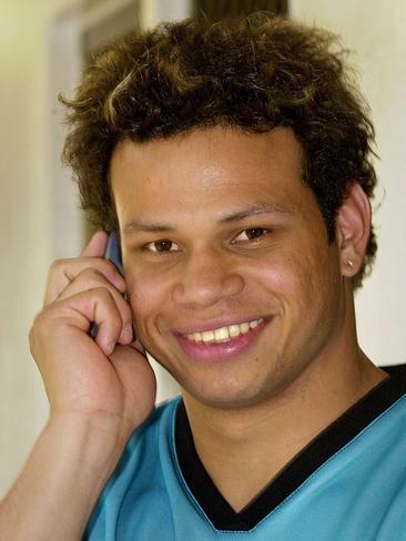 Footballer Daniel Motlop talking on mobile phone in Darwin, 2005