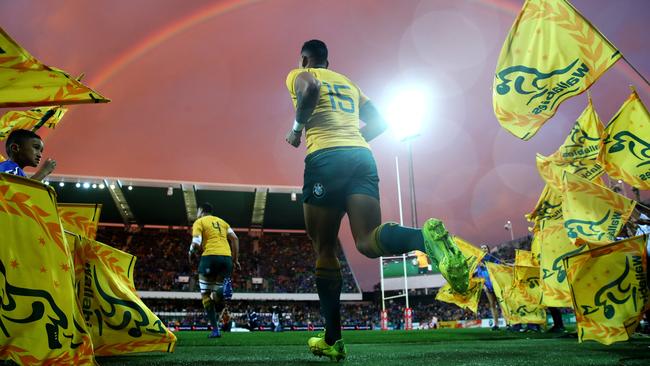 Folau runs onto nib Stadium under a rainbow. Picture: Cameron Spencer/Getty Images