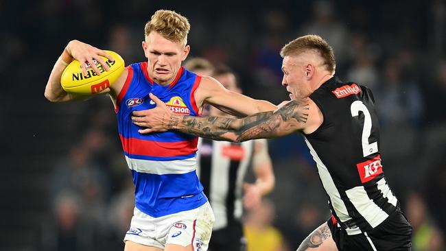 Adam Treloar of the Bulldogs is tackled by Jordan De Goey of the Magpies. Photo by Quinn Rooney/Getty Images