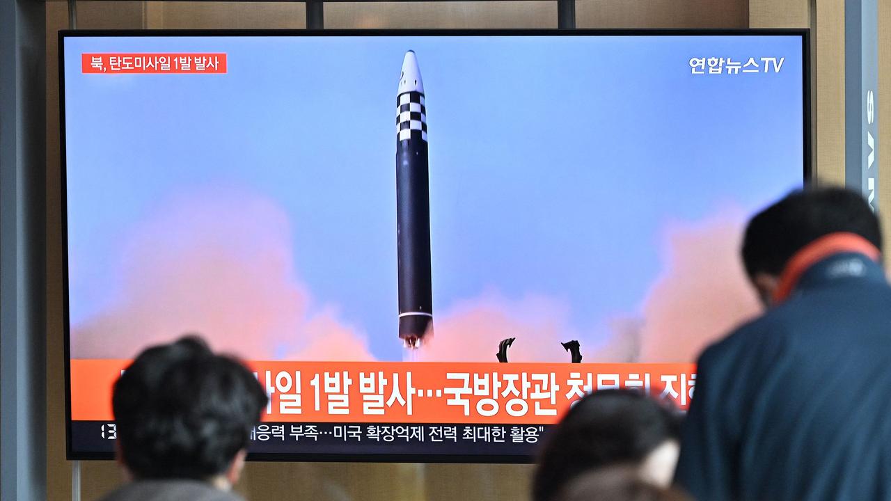 People watch footage of a North Korean missile test. North Korea fired a ballistic missile on May 12 after announcing its first Covid case. Picture: AFP.