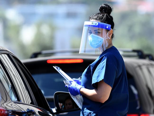 SYDNEY, AUSTRALIA - NewsWire Photos FEBRUARY, 22, 2021: NSW Health workers dressed in Personal Protection equipment (PPE) are seen at the St Vincents Hospital COVID-19 drive through testing clinic at Bondi Beach, Sydney. Australia has begun its Pfizer COVID-19 vaccination rollout this morning, with hopes 60,000 doses will be administered by the end of the week. NCA NewsWire/Bianca De Marchi