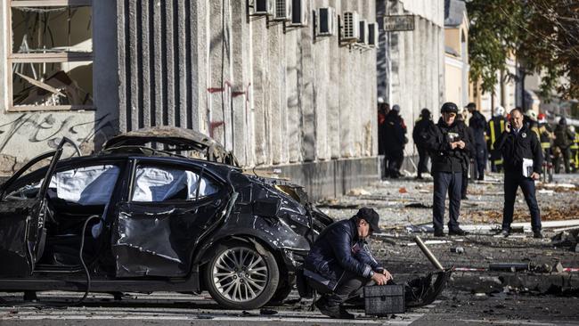 Emergency service personnel attend to the site of a blast in Kyiv.