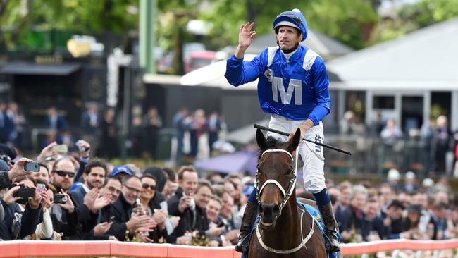 Hugh Bowman celebrates after riding Winx to the line to win the William Hill Cox Plate. Cox Plate Race Day 2016 at Moonee Valley Racecourse. Picture: Nicole Garmston