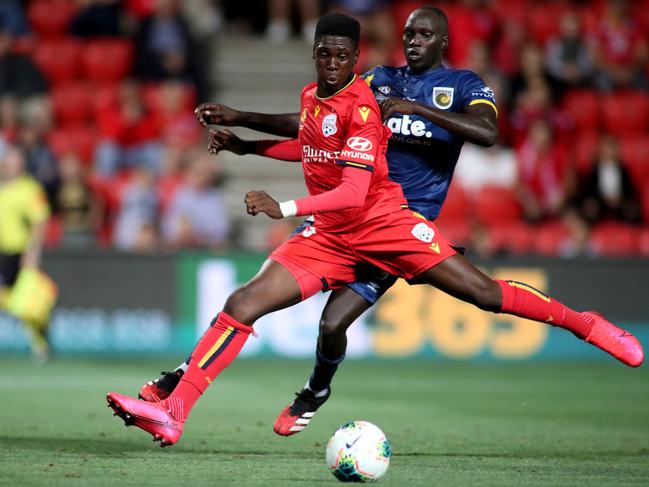Mohamed Toure of United is tackled by Ruon Tongyik of the Mariners during the Round 19 A-League match between Adelaide United and Central Coast Mariners at Coopers Stadium in Adelaide, Friday, February 14, 2020. (AAP Image/Kelly Barnes) NO ARCHIVING, EDITORIAL USE ONLY