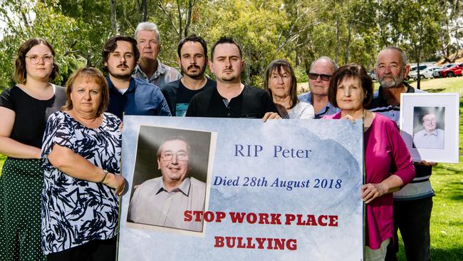 Peter Howards family Emma Acella, Sharon Howard, Jacob Howard, Kevin Schwartz, Cameron Howard, Nathan, Ingrid, Paul Howard, Carmel Schwartz and Tom Howard standing together holding a banner and photo of Peter, who took his own life. Picture: Morgan Sette