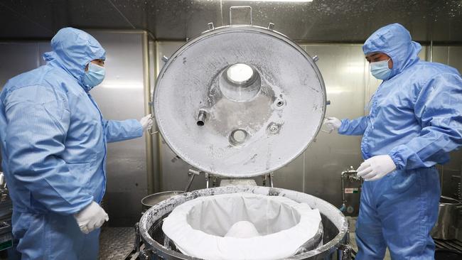 Workers produce medicine at a pharmaceutical factory in Lianyungang, in China's eastern Jiangsu province on December 20.