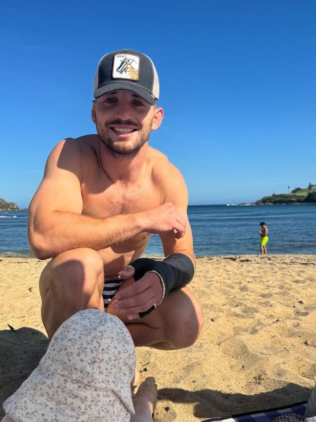 Cameron Murray enjoys some time on the beach with his young family as he recovers from a wrist injury.