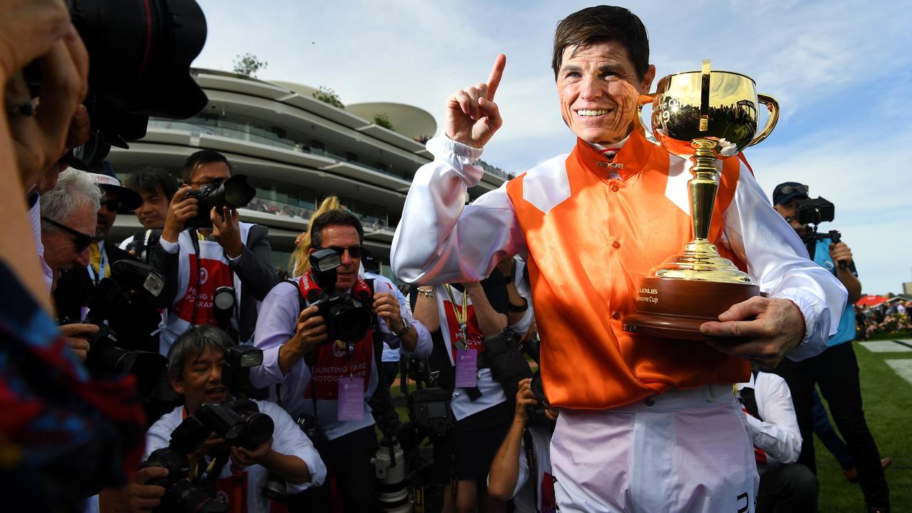 Jockey Craig Williams holds the Melbourne Cup trophy. Picture: AAP