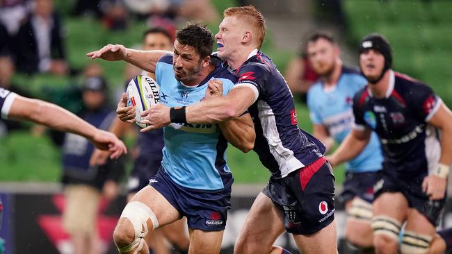 Campbell Magnay of the Rebels tackles Waratahs opponent Jake Gordon. Picture: AAP