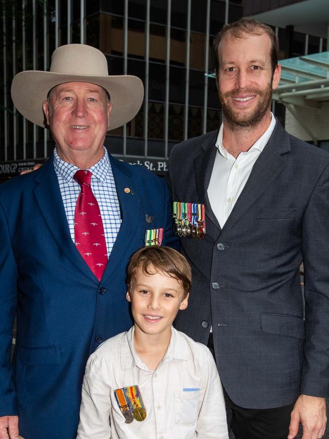Thousands of people have braved the rain to gather in Brisbane for Anzac Day services. Picture: Grace Kessels