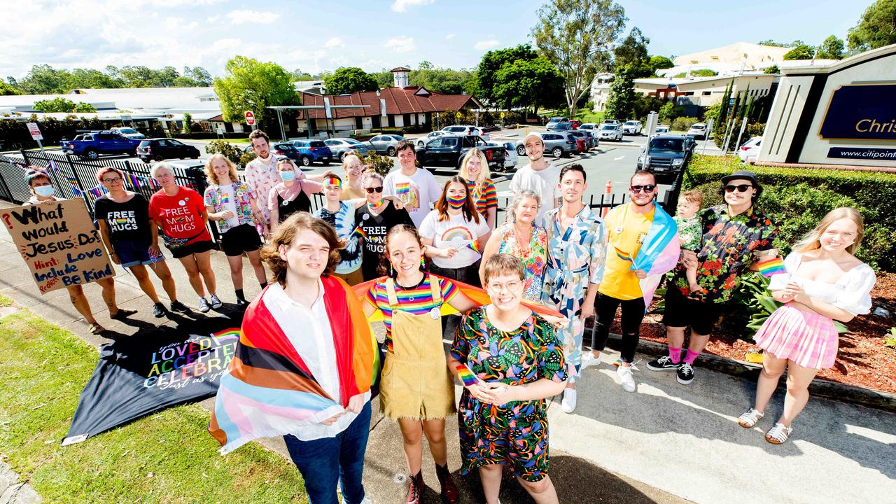 Emmey Leo with Felicity Myers and Bethany Lau protest outside Citipointe Christian College on Monday. Picture: Richard Walker