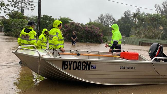 Scrambling to move items to higher ground at Urunga on Wednesday morning.