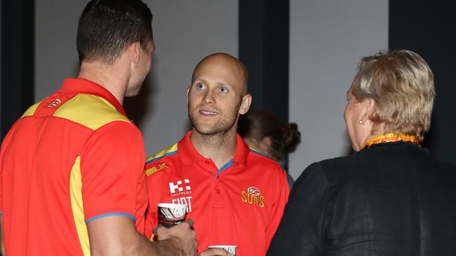 Gold Coast players Steven May and Gary Ablett talks to a member. Picture: Regi Varghese