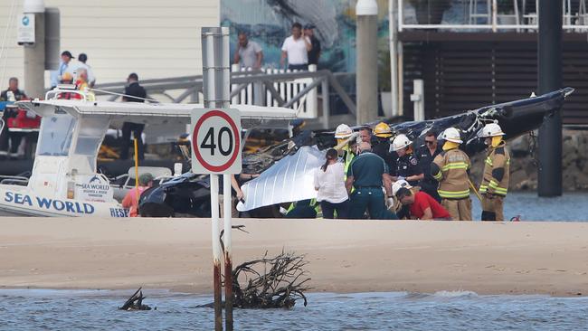 Emergency services at the scene of a Helicopter crash between two Sea World Helicopters just outside the tourist park on a sandbank in the Southport Broadwater. Picture Glenn Hampson