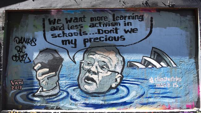 A mural depicting Prime Minister Scott Morrison in a flooded Sydney harbour holding a lump of coal painted by the nephew of former prime minister Kevin Rudd, artist Van T Rudd is seen in Hosier Lane in Melbourne. Picture: AAP