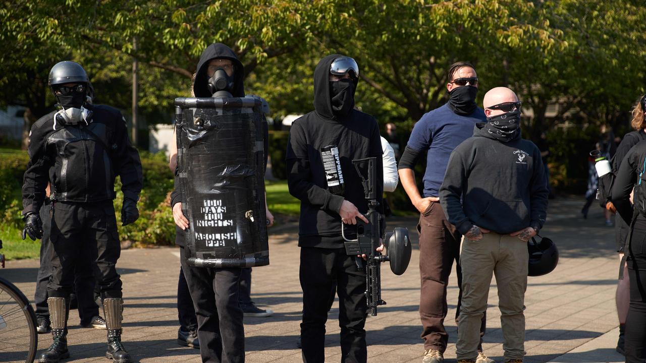 Members of Antifa stand with a shield and paintball gun in the street. Picture: Allison Dinner/AFP