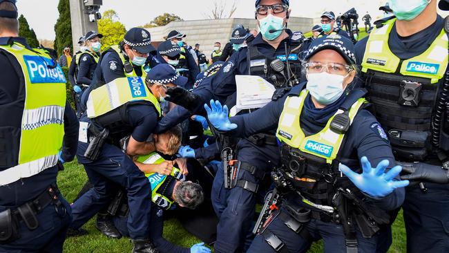 Police tackle protesters in Melbourne on September 5 during an anti-lockdown rally protesting the state's strict lockdown laws. Picture: AFP