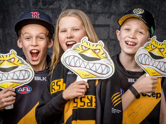 Tiger masks. Thomas Ballek, 11, Anna Boterham, 13 and Alexander Grant, 11 hold Herald Sun Tiger masks. Picture: Jake Nowakowski