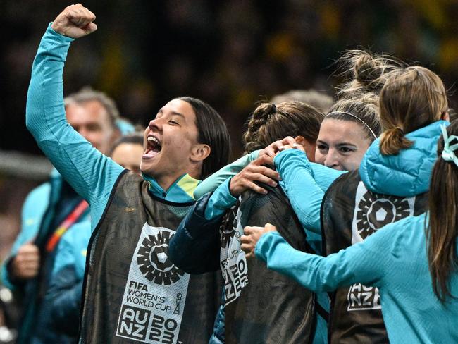 Sam Ker enjoys Steph Catley’s injury time penalty with her teammates. Picture: AFP