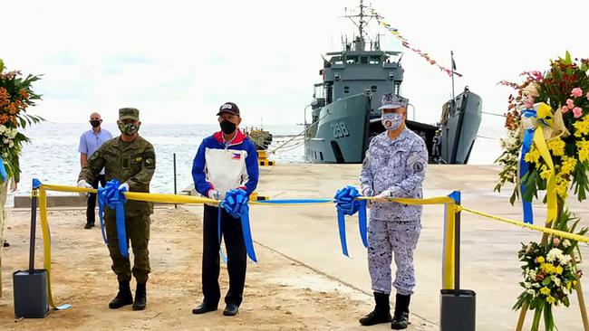 Philippines Defence Secretary Delfin Lorenzana, centre, launches the new beach-ramp at Pag-Asa island. Picture: AFP