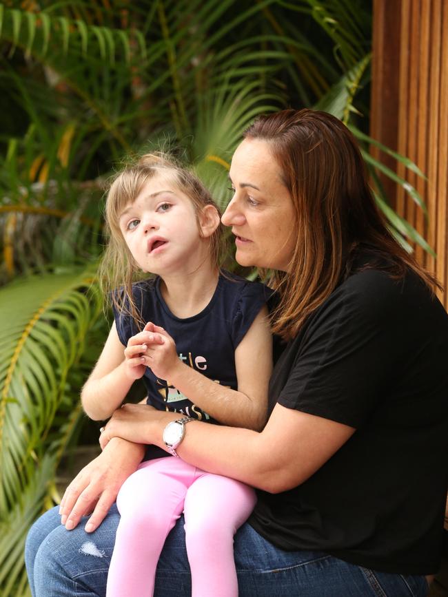 Pictured at their Hope Island home Kylie Moore and her disabled daughter Maddie Clarkin age 8 who are waiting for the NDIS to kick in. Picture Mike Batterham