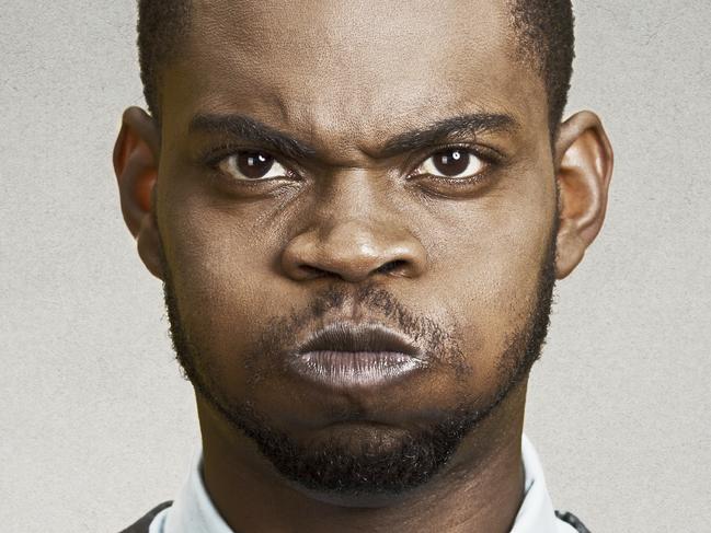 Closeup portrait angry young business man, blowing steam, about to have nervous atomic breakdown, isolated black background. Negative human emotions, facial expressions, reaction, feelings attitude