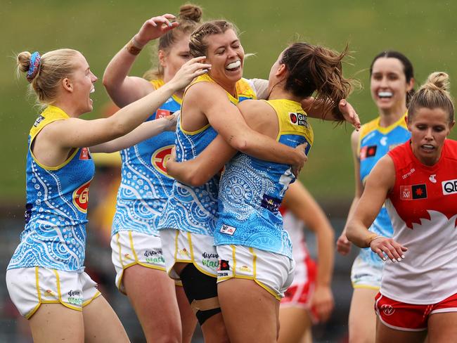 SYDNEY, AUSTRALIA - OCTOBER 08: Claudia Whitfort of the Suns celebrates with her team after kicking a goal during the round seven AFLW match between the Sydney Swans and the Gold Coast Suns at Henson Park on October 08, 2022 in Sydney, Australia. (Photo by Mark Kolbe/Getty Images)