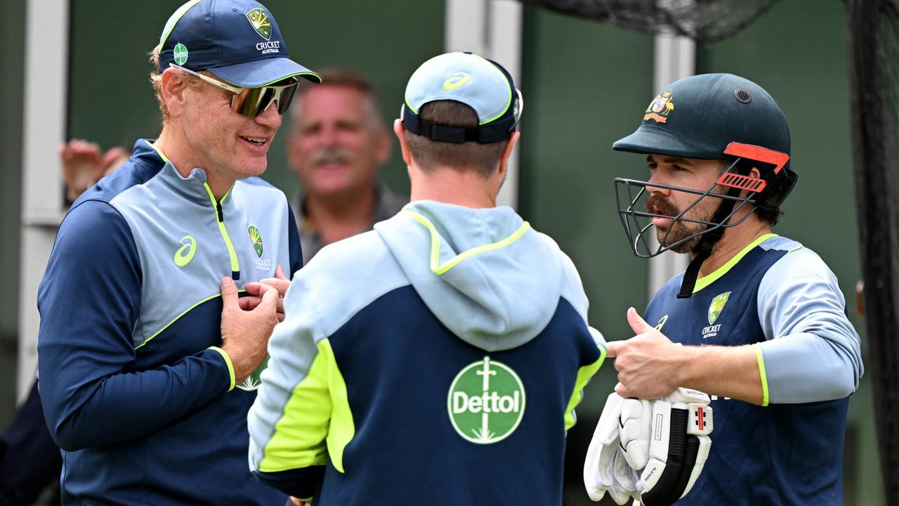 Travis Head (right) talks to Australian coach Andrew McDonald (left) and physio Nick Jones (centre) after his brief net session at the MCG on Christmas Eve. Picture: William West / AFP