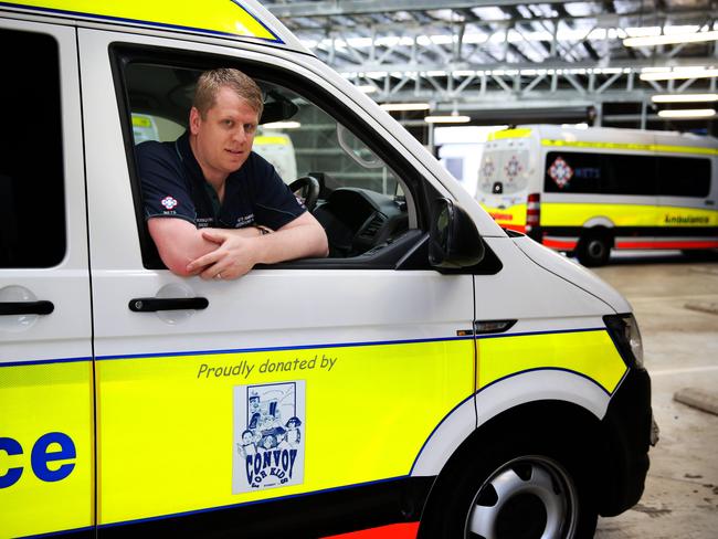 Operations and facility manager Josh Emanuel sits in the ambulance that Convoy for Kids Sydney helped fund. Picture: Angelo Velardo