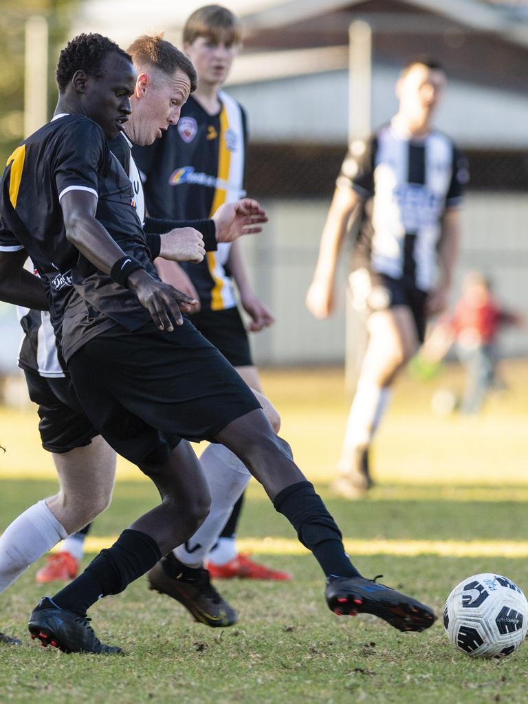 Wek Wek (left) of West Wanderers and Ben Barrowclift of Willowburn in FQPL Men Darling Downs Presidents Cup football at West Wanderers, Sunday, July 24, 2022. Picture: Kevin Farmer