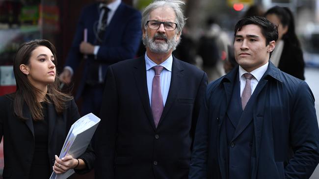 John Jarratt, centre, outside the Downing Centre in Sydney before the rape case against him was thrown out. Picture: AAP