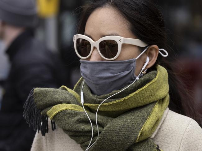 LONDON, ENGLAND - APRIL 01: A woman wears a face mask while walking on Oxford Street on April 01, 2022 in London, England. From today, guidance on voluntary COVID-status certification in domestic settings and the use of the NHS Covid Pass plus requirements for employers to consider COVID-19 in health and safety risk assessments is removed. Free universal symptomatic and asymptomatic testing for the general public is no longer provided with Lateral Flow Tests now available to purchase on the High Street. (Photo by Dan Kitwood/Getty Images)