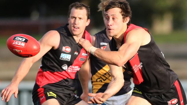 Kaine Stevens (West Adelaide) handballs during the final quarter against Glenelg. Picture: Stephen Laffer