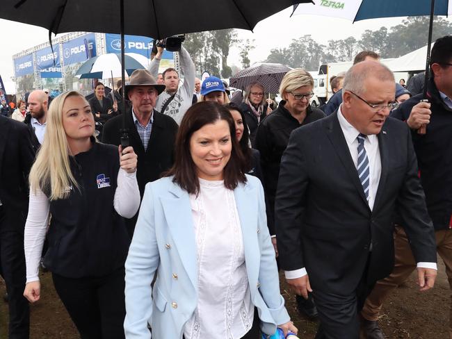 Jessica Whelan, left, carries an umbrella for Prime Minister Scott Morrison at Agfest. Picture: GARY RAMAGE