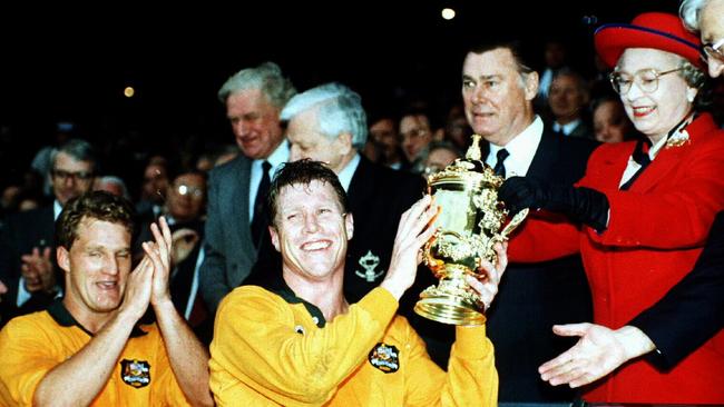 Nick Farr-Jones, centre, with the Rugby World Cup trophy in 1991. Picture: Action Photographics