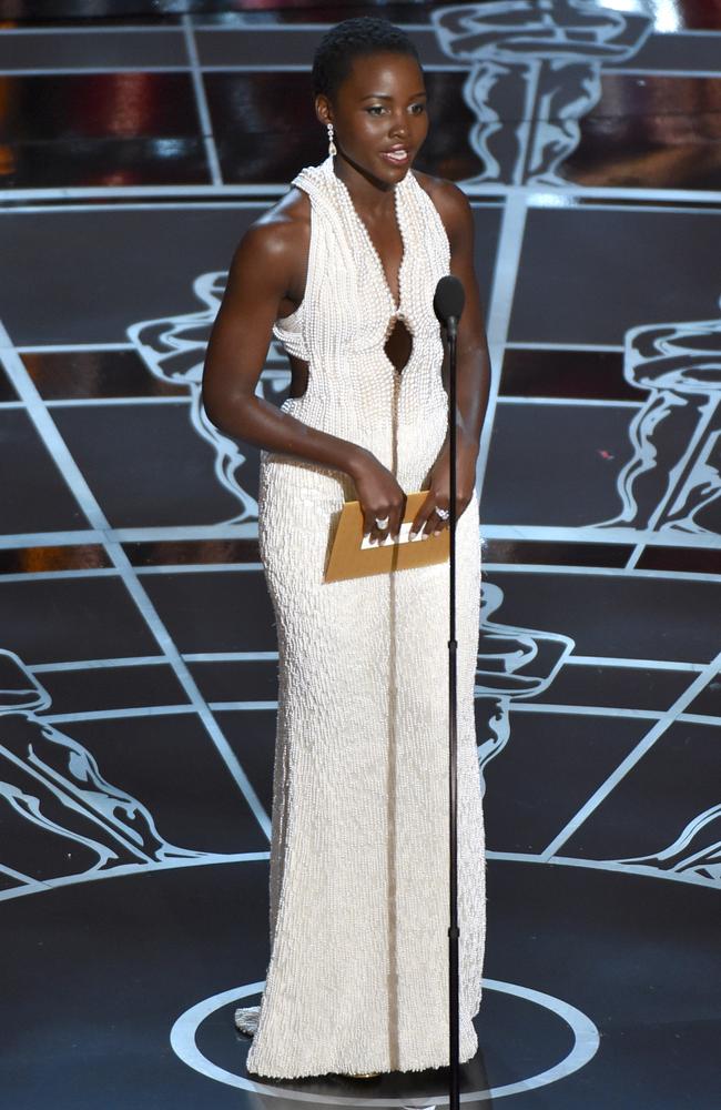 Lupita Nyong'o wears a pearl dress as she presents an award at the Oscars in Los Angeles.