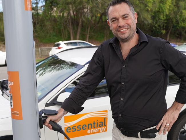 EVX chief executive Andrew Foster uses the trial streetlight EV charger in Port Macquarie, New South Wales. It was created as a collaboration between Essential Energy, Toowoomba firm Wagners and EVX.