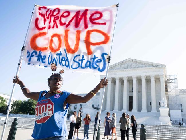 TOPSHOT - A protestor is seen outside of the US Supreme Court on the first day of a new term in Washington, DC, on October 7, 2024. The US Supreme Court returns from its summer recess on Monday with regulation of "ghost guns" -- firearms made from kits -- and medical care for transgender youth on a docket that risks being gate-crashed in the event of a contested presidential election. (Photo by SAUL LOEB / AFP)