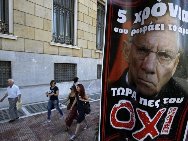 Familiar sight around Athens ... A poster depicting German Finance Minister Wolfgang Schaeuble reading ''For five years he is drinking your blood, now tell him NO'' Picture: AP/Thanassis Stavrakis